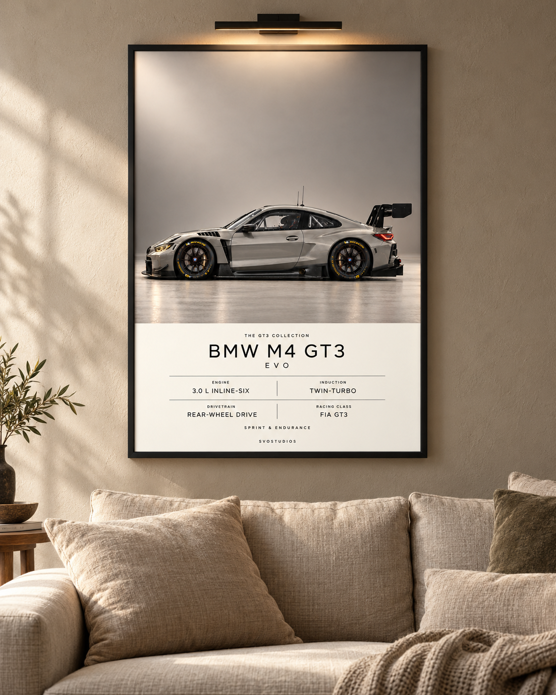 BMW M4 GT3 EVO — GT3 Studio Edition in a black Classic frame above a neutral sofa with warm picture lighting