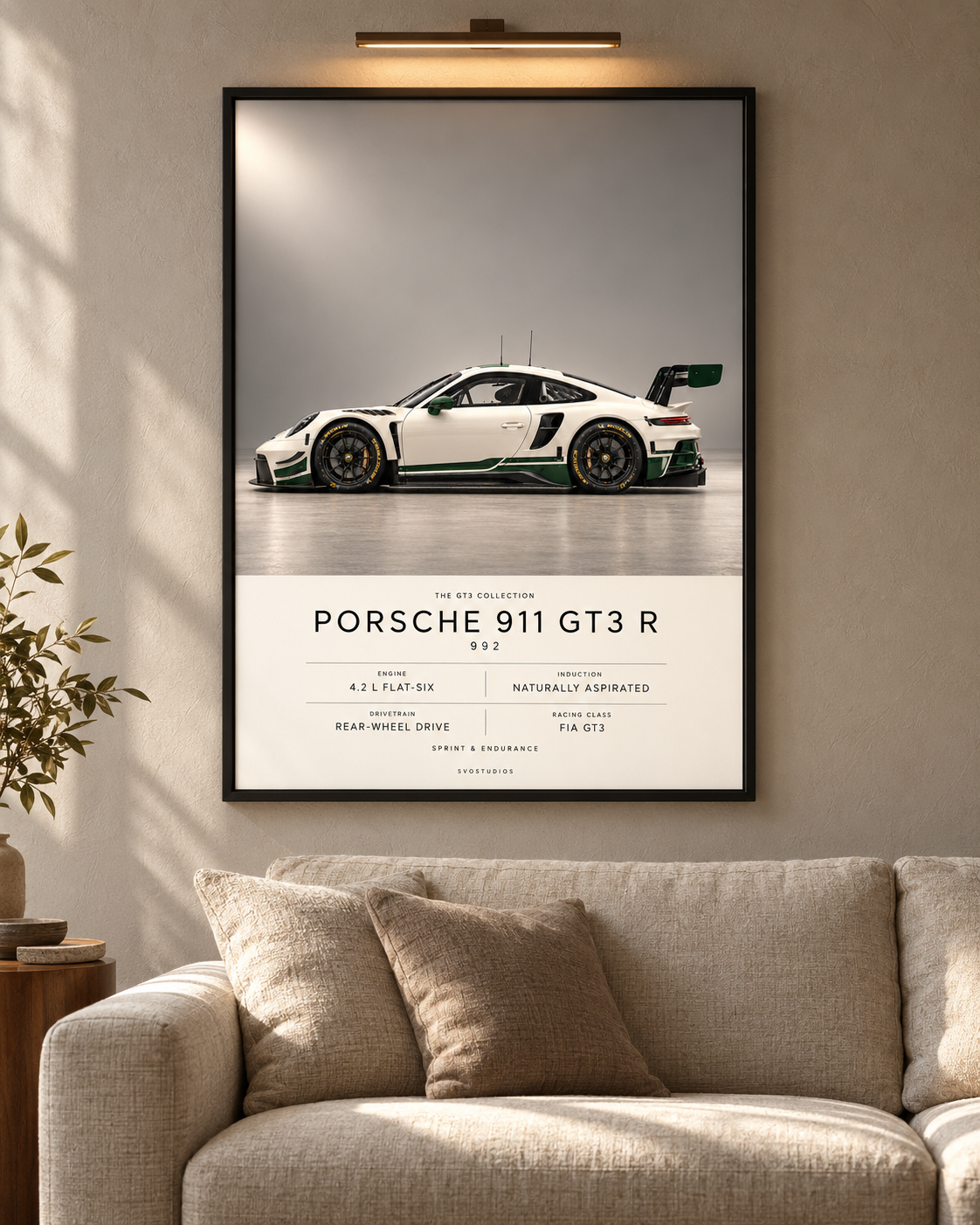 Porsche 911 GT3 R (992) — GT3 Studio Edition in a black Classic frame above a neutral sofa with warm picture lighting