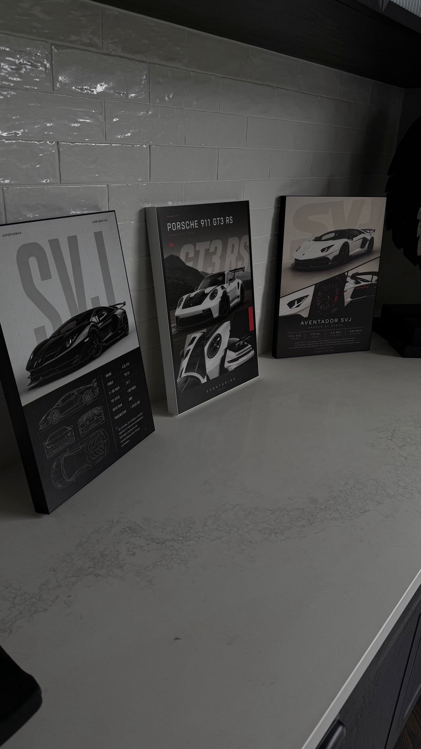 Black Aventador SVJ blueprint with other physical SVOSTUDIOS framed artworks